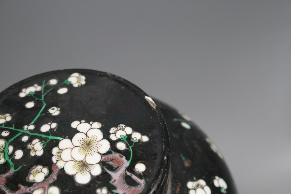 A pair of Chinese famille noire ginger jars and covers, decorated with prunus, height 20cm, and a blue and white dish, 34cm